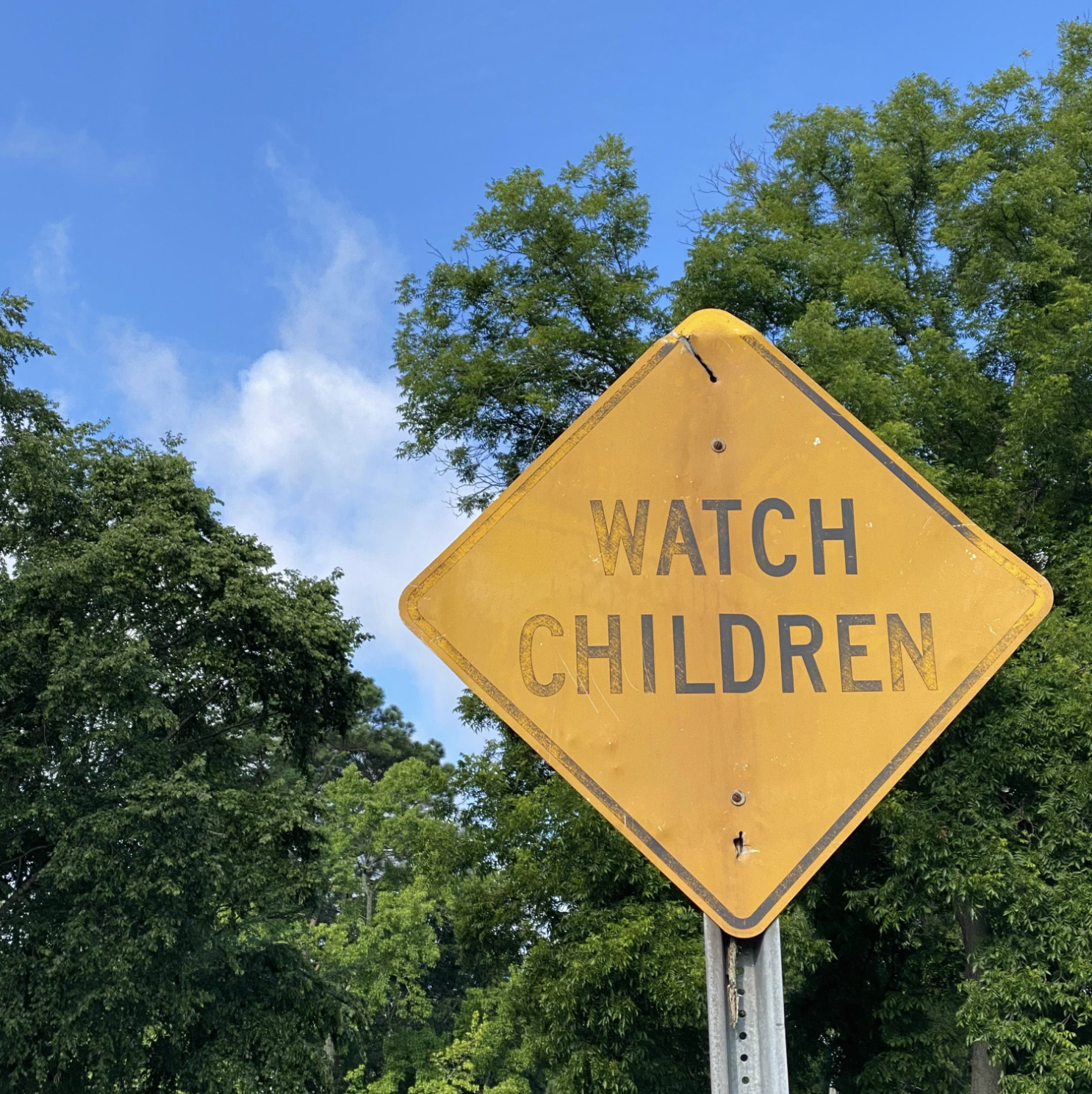A faded caution sign with the words "Watch Children"